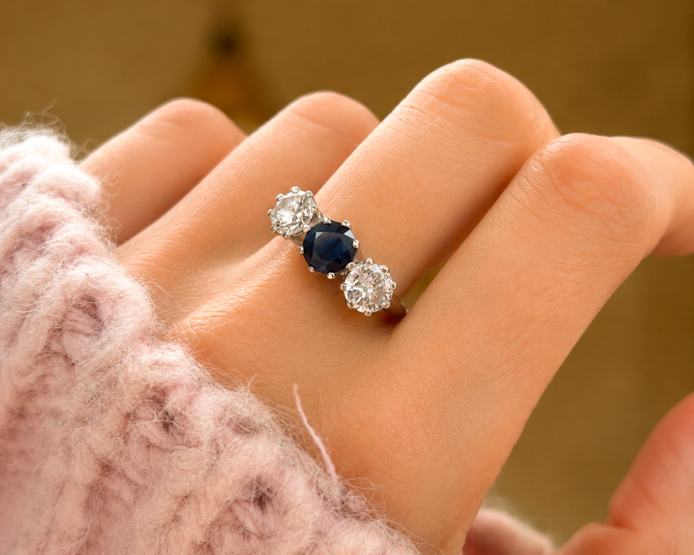 antique 1930s sapphire and diamond ring in 18ct white gold for sale in Leeds, shown on a hand