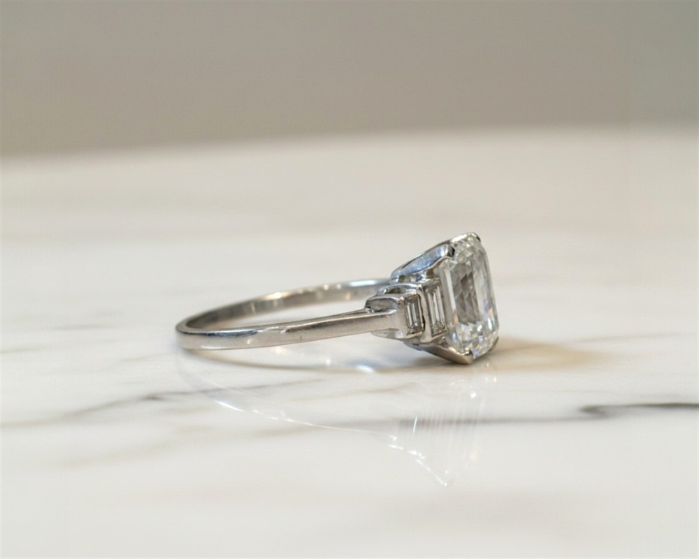 antique Art deco emerald cut diamond ring with 2.83ct stone and baguette cut diamond shoulders for sale in Leeds showing side view