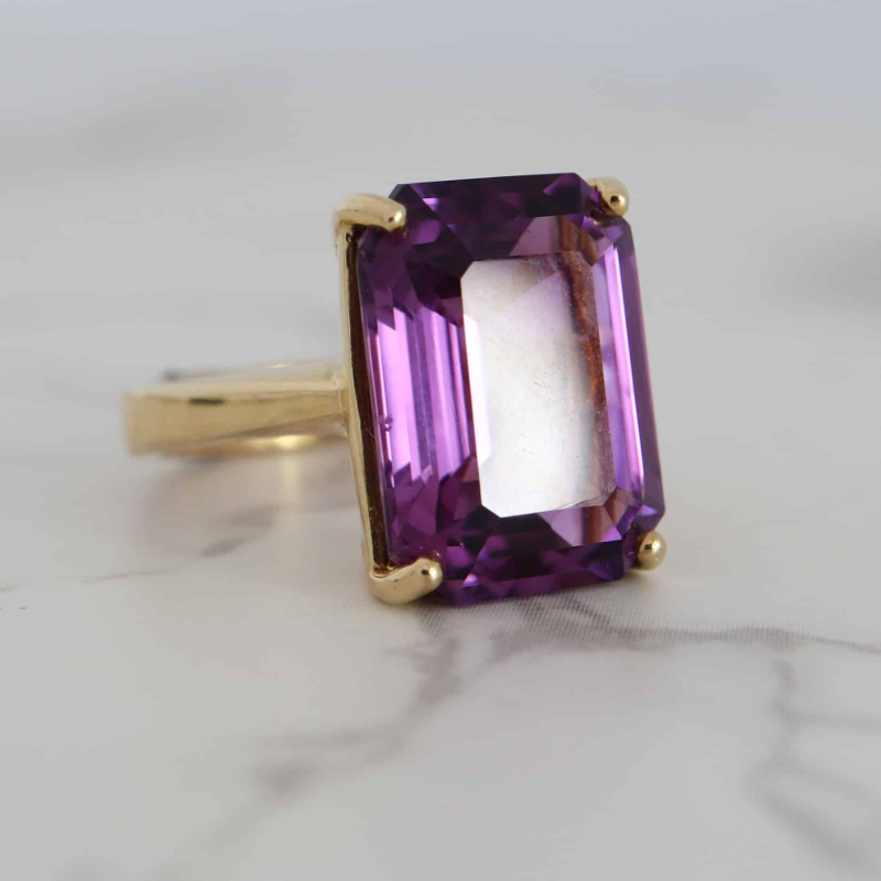 modern 9ct gold and amethyst emerald cut ring for sale in Leeds, Yorkshire side angle view