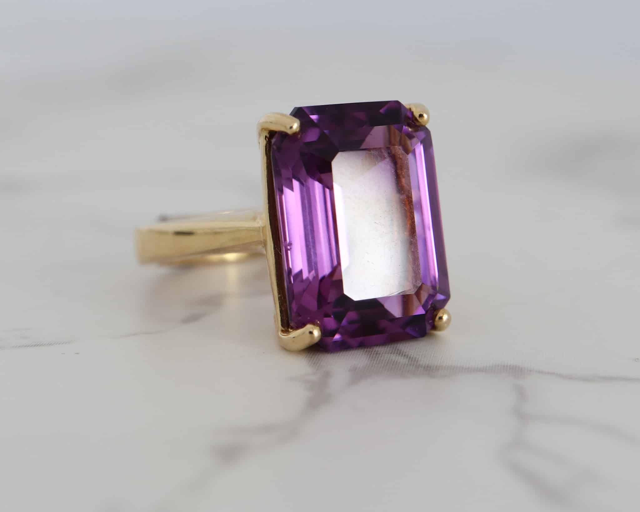 modern 9ct gold and amethyst emerald cut ring for sale in Leeds, Yorkshire side angle view