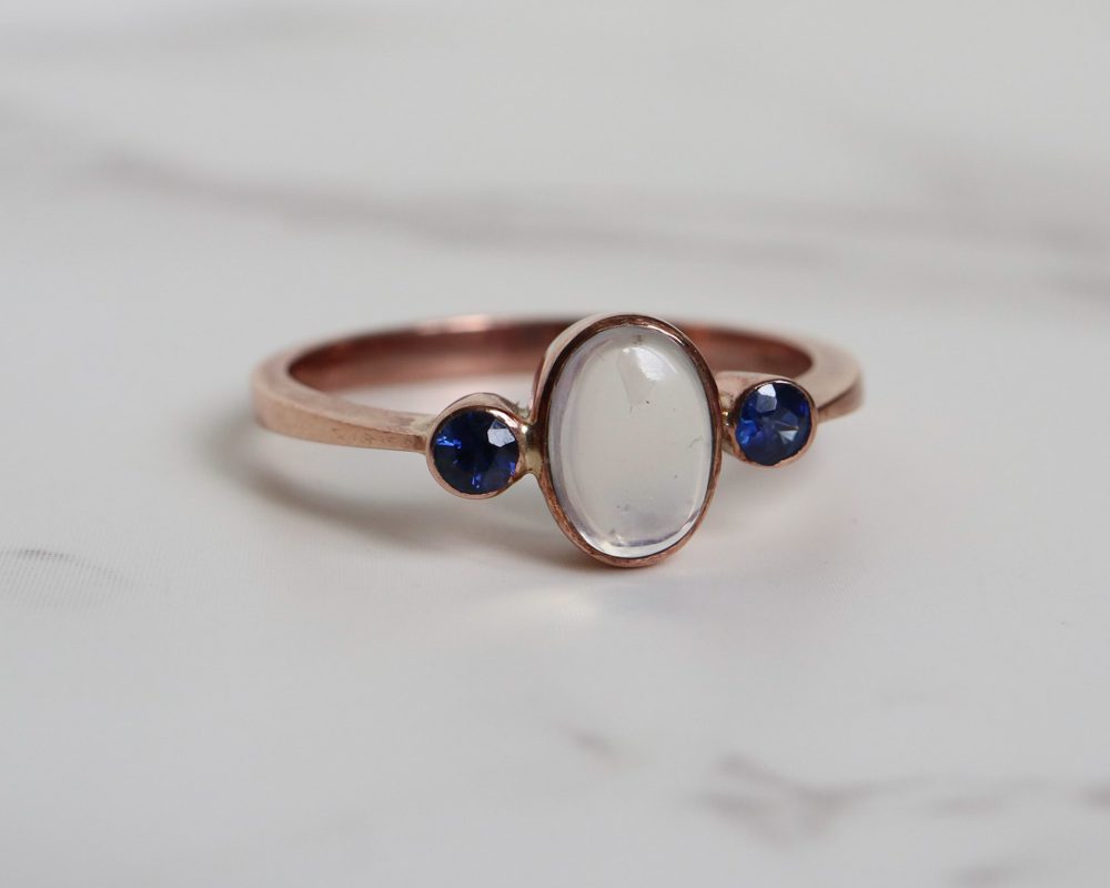 Contemporary sapphire and moonstone ring set in 9ct rose gold for sale in Leeds, Yorkshire