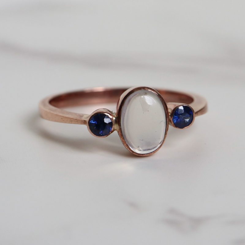 Contemporary sapphire and moonstone ring set in 9ct rose gold for sale in Leeds, Yorkshire