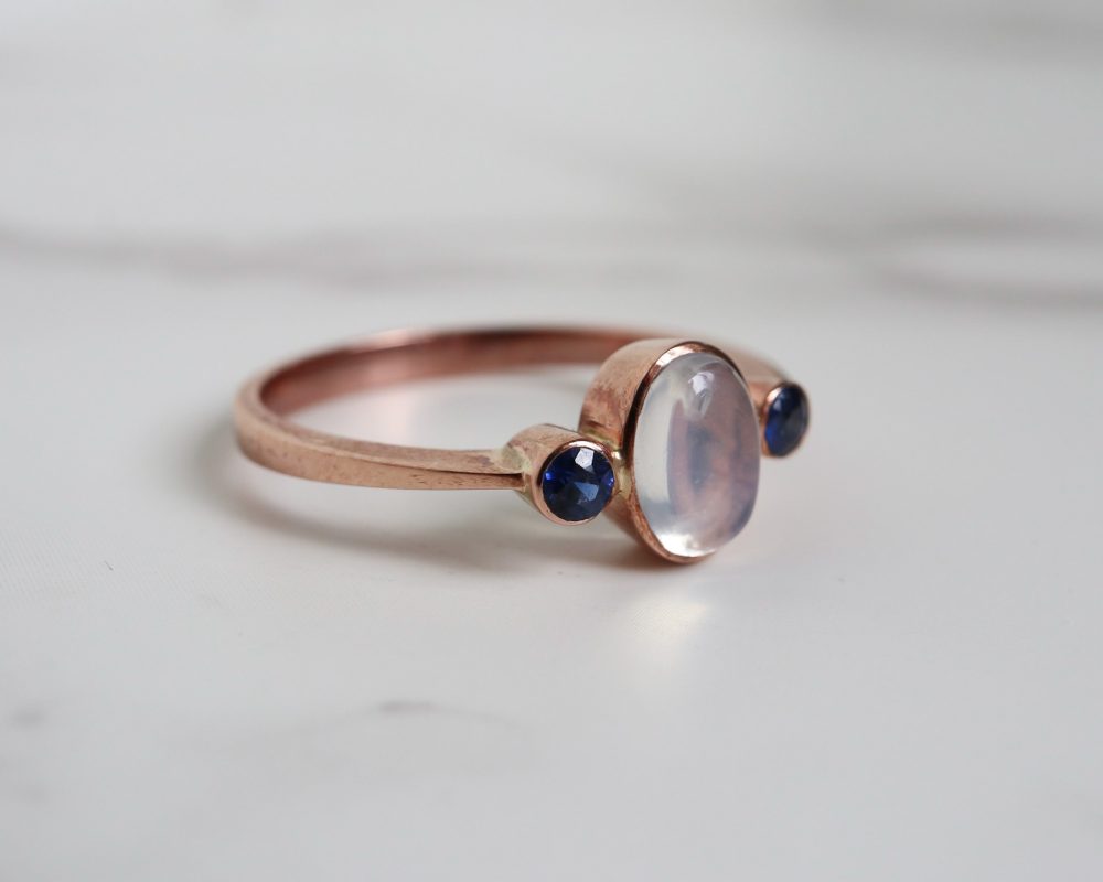 Contemporary sapphire and moonstone ring set in 9ct rose gold for sale in Leeds, Yorkshire
