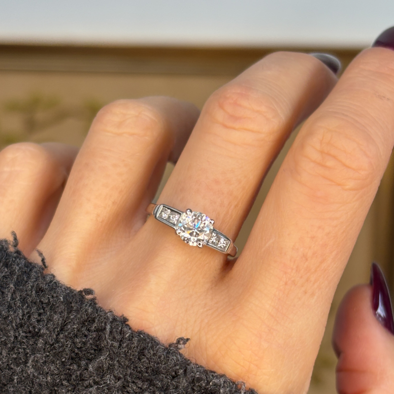 vintage diamond solitaire ring 1ct brilliant cut, diamond shoulders in 18ct white gold, shown on lady's hand