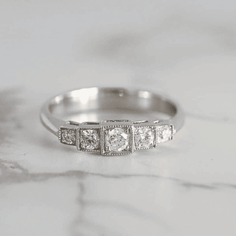 art deco style five stone diamond ring for sale in Yorkshire front view on marble