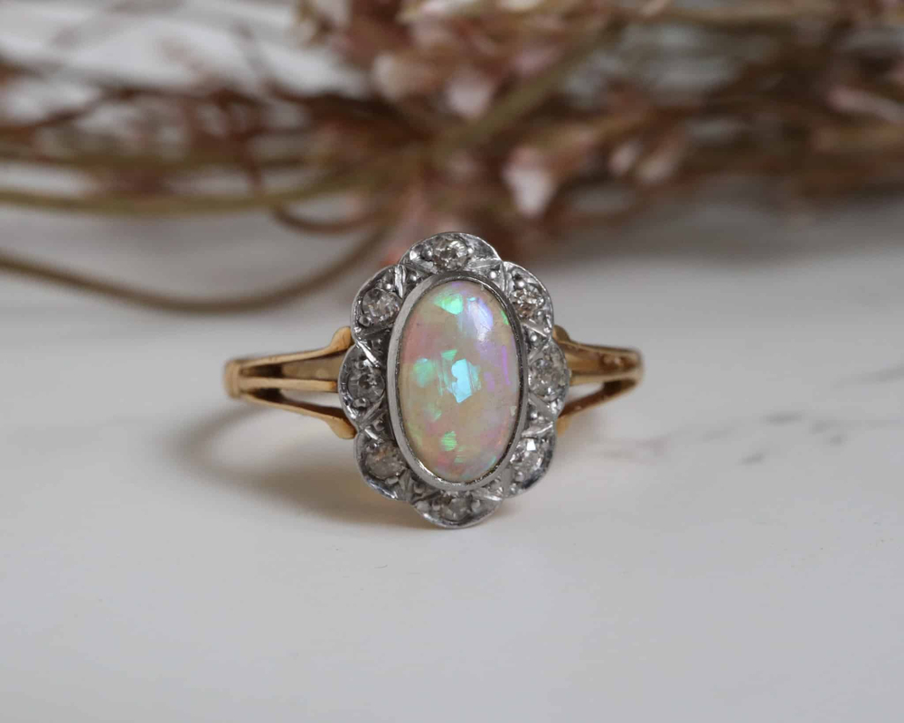 antique Edwardian opal and diamond cluster ring in 18ct yellow gold with split shank shoulders with background