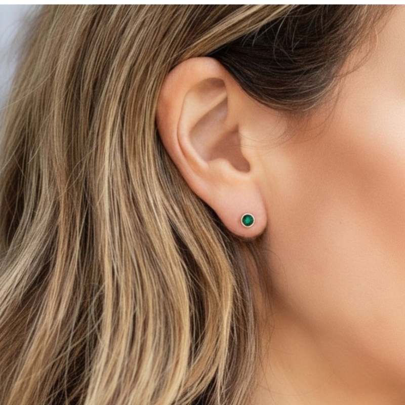 9ct gold emerald bezel set micro studs for sale in model's ear