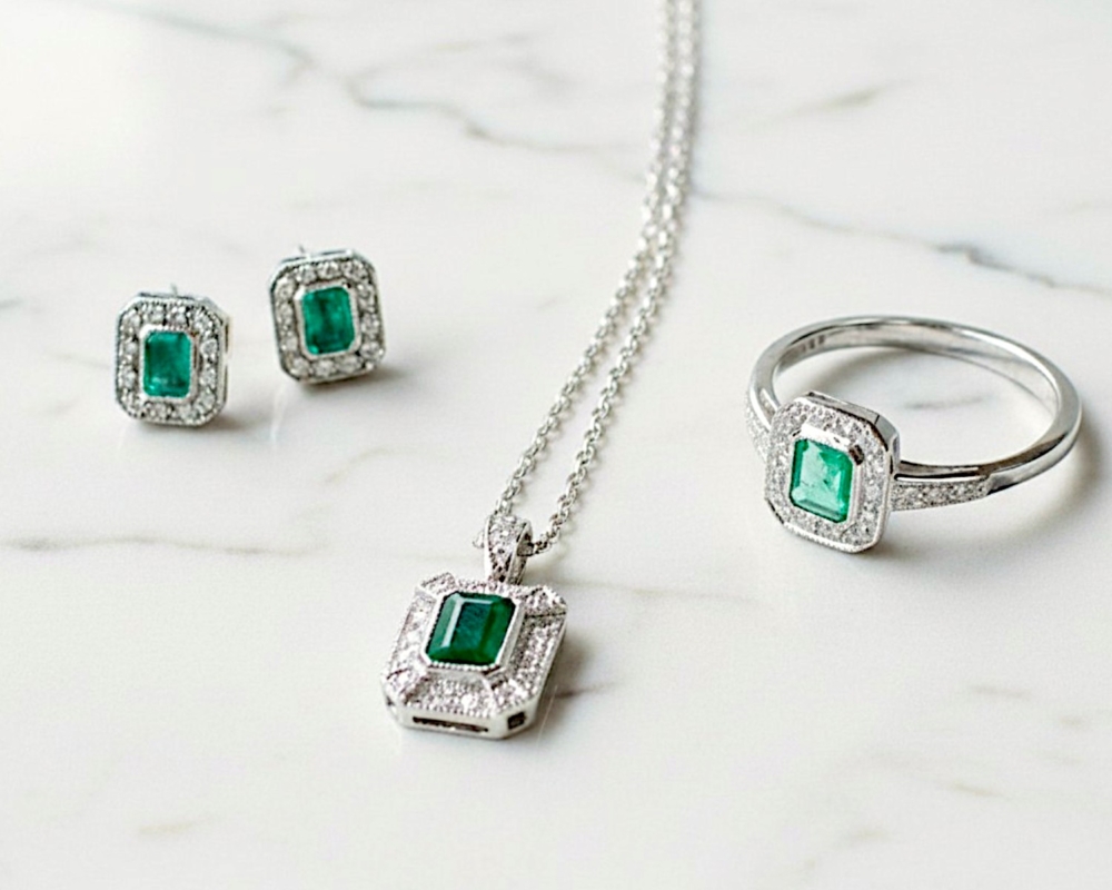 art deco style emerald and diamond studs in white gold for sale in Leeds shown here with matching pendant and ring