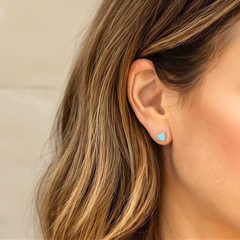 silver and light blue heart shaped opal studs for sale in Leeds in model's ear