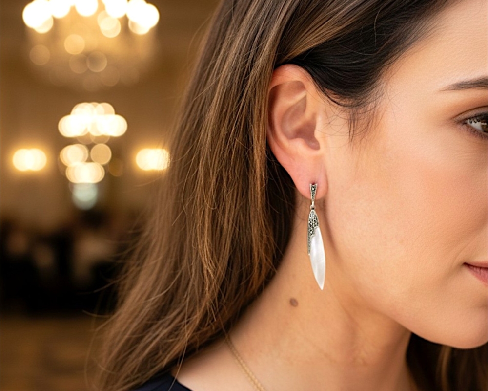vintage style mother of pearl drop earrings for sale in Leeds set with silver and marcasite in an Art Deco style shown in a model's ear