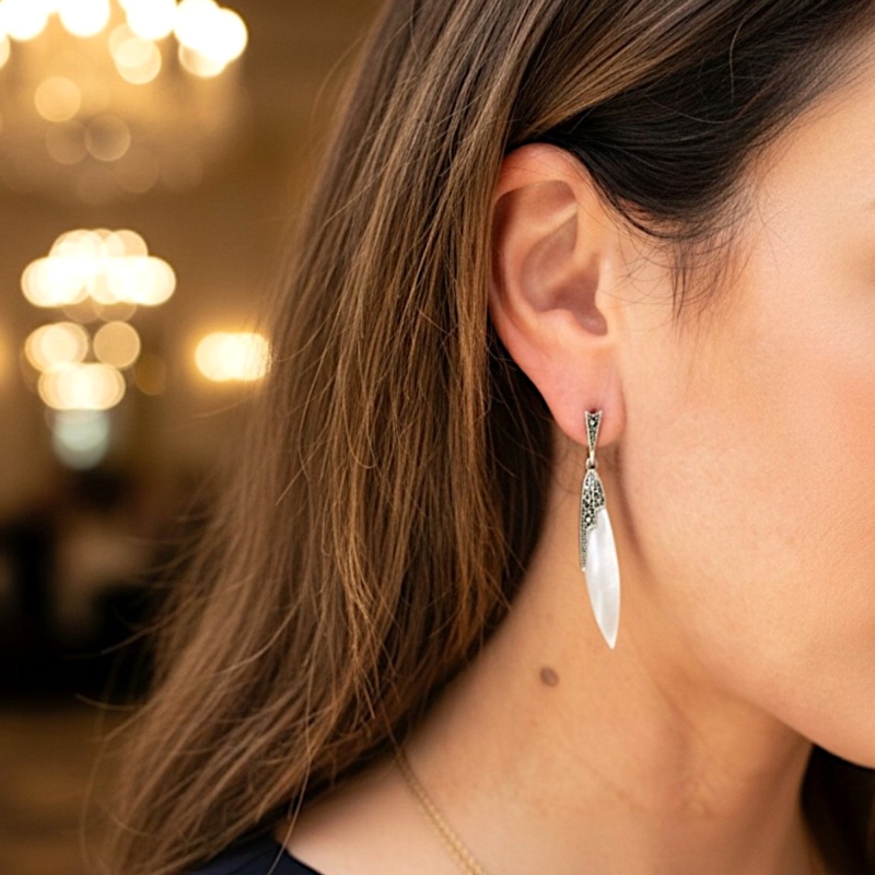 vintage style mother of pearl drop earrings for sale in Leeds set with silver and marcasite in an Art Deco style shown in a model's ear