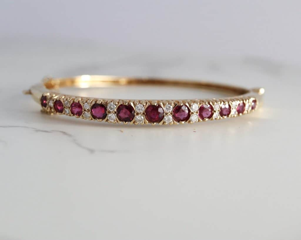 modern ruby and diamond bangle in 9ct yellow gold for sale in Leeds front view