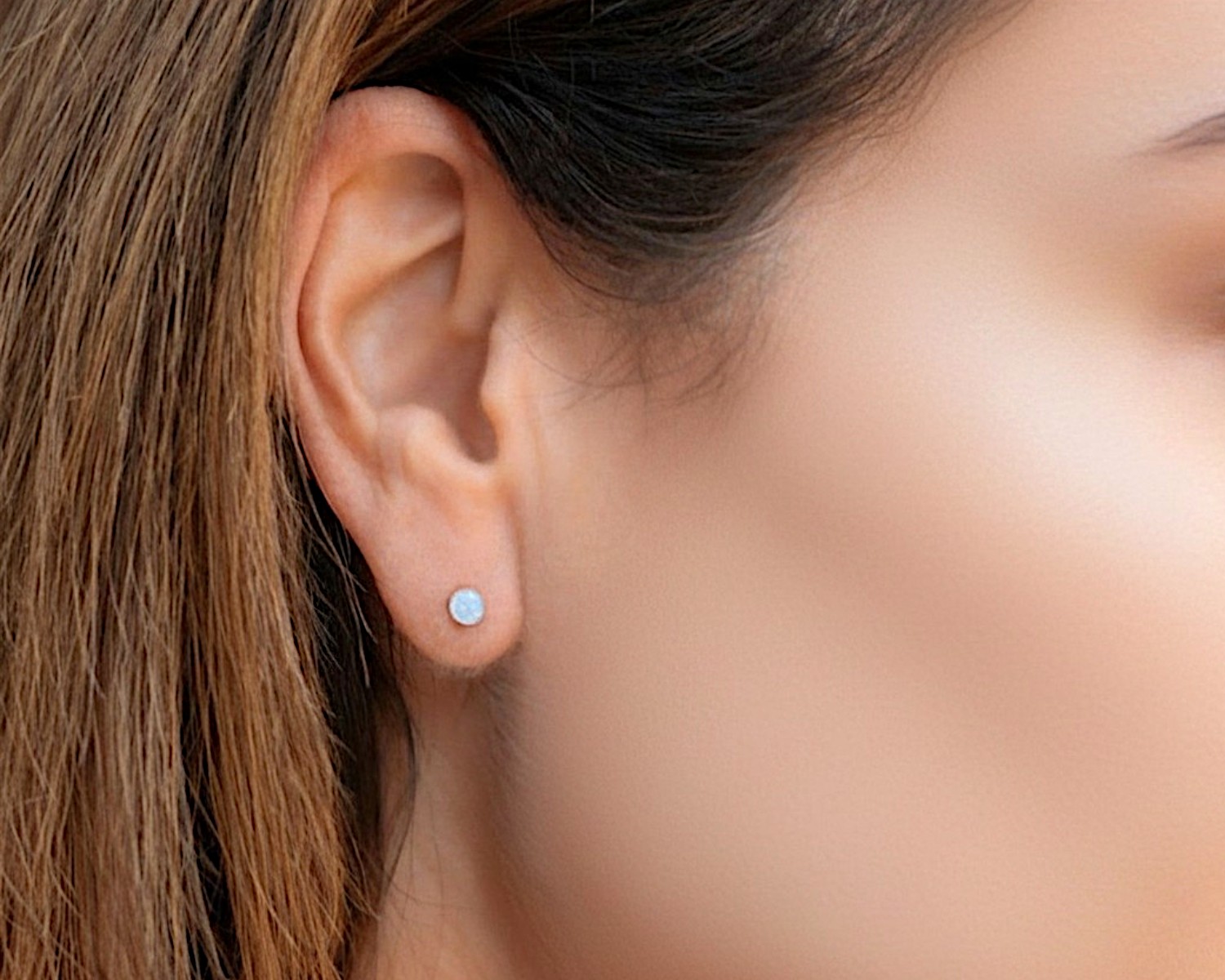 small opal studs on model