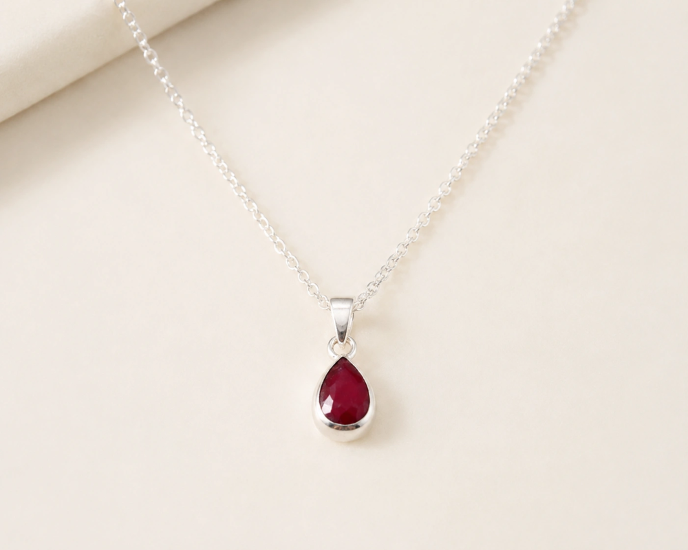 silver and ruby pendant in a pear cut shape