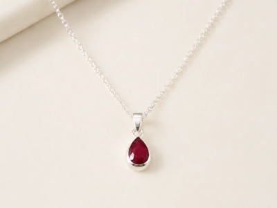 silver and ruby pendant in a pear cut shape