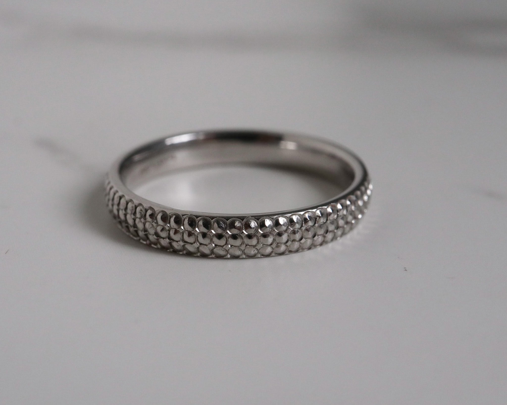Contemporary platinum band with textured pattern