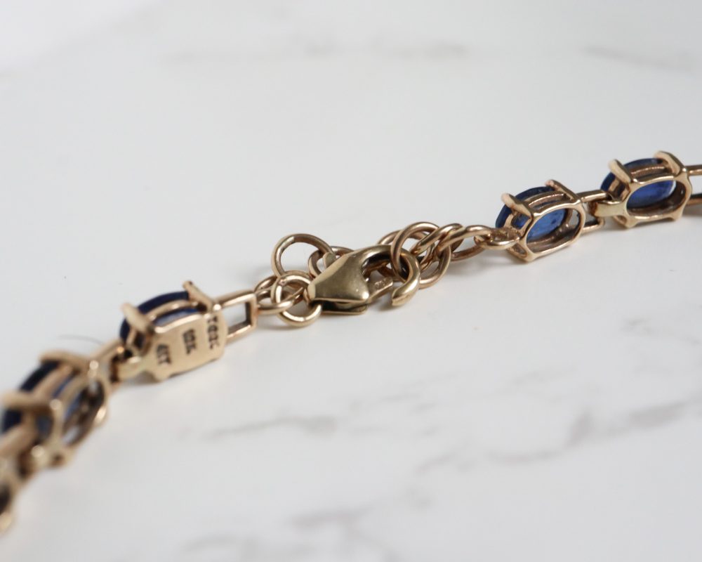 Modern sapphire tennis bracelet set in 10ct gold for sale in Leeds, Yorkshire