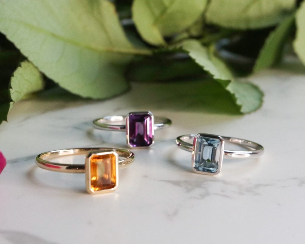 9ct white gold and blue topaz emerald cut ring in a bezel setting