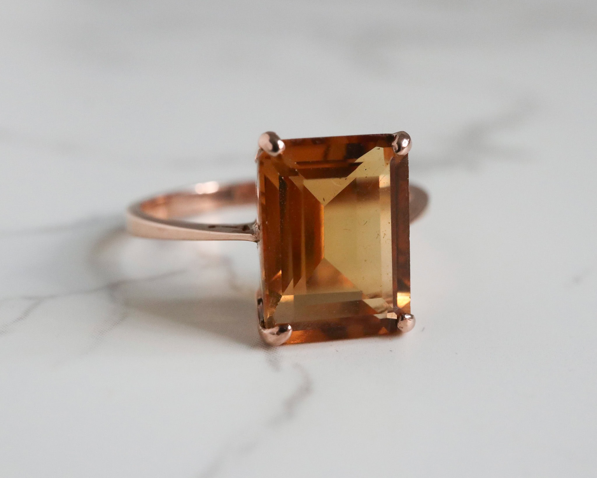Modern 9ct rose gold citrine ring in an emerald cut stone