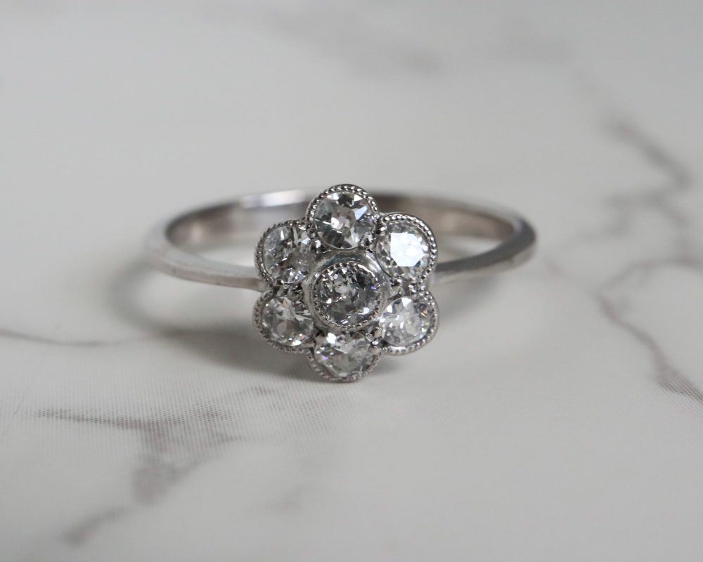 Antique Edwardian diamond daisy ring set in 18ct white gold for sale in Leeds, Yorkshire