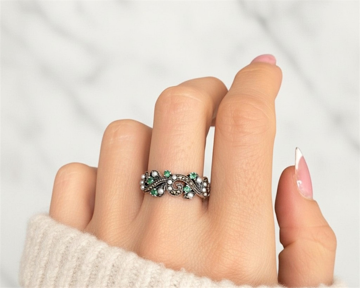 vintage style silver emerald ring on model's hand for sale in leeds