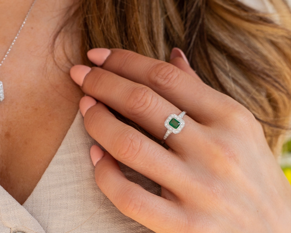 art deco style emerald and diamond ring in 9ct white gold for sale, on woman's hand