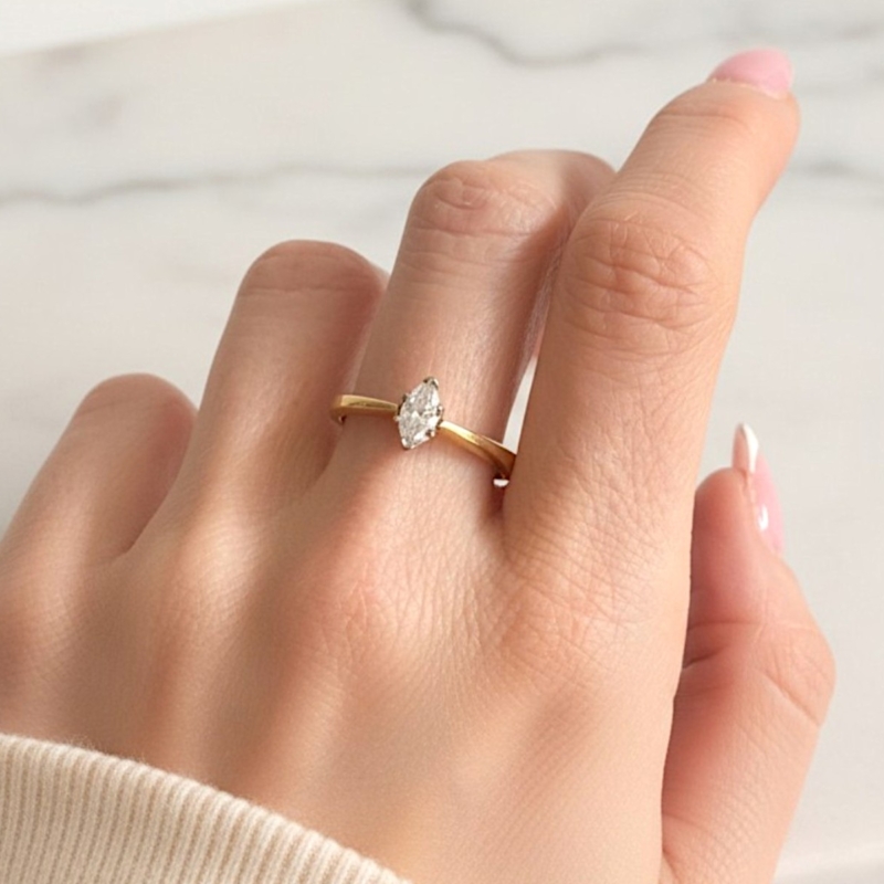 vintage marquise cut diamond solitaire ring shown on model's hand