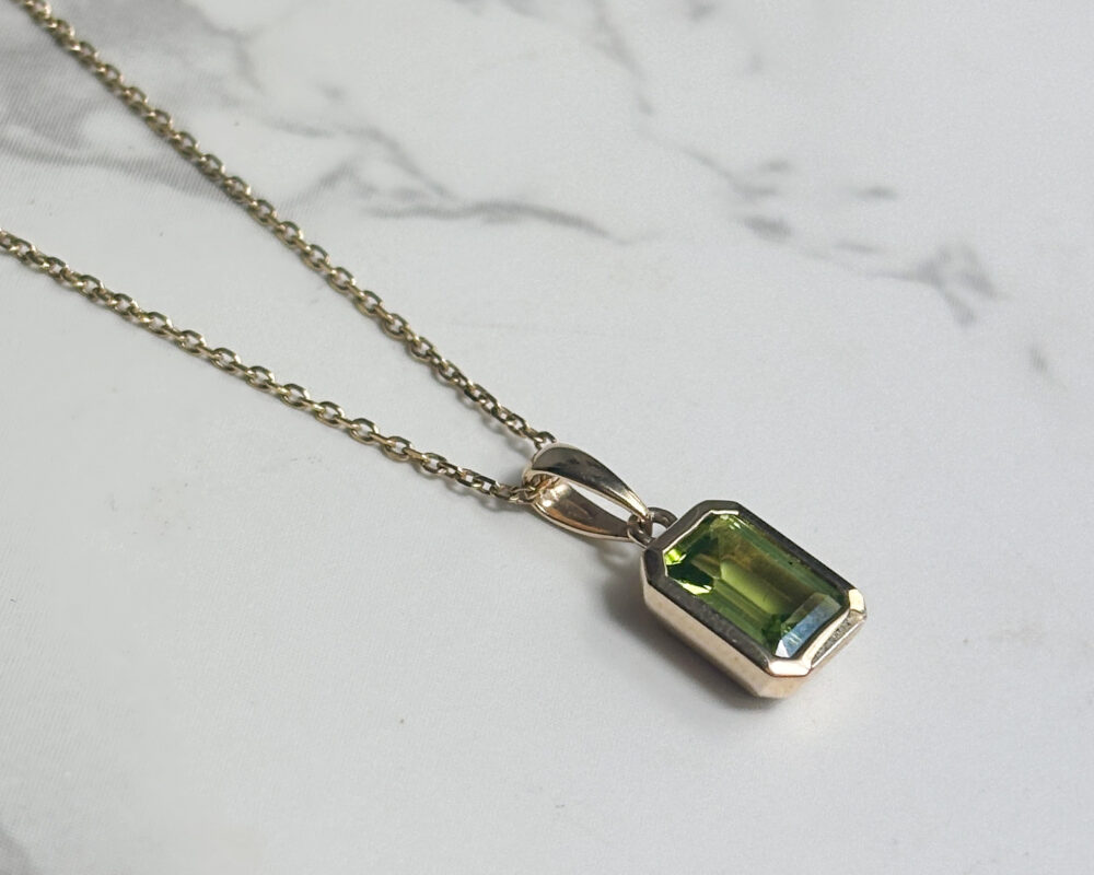 modern 9ct yellow gold and emerald cut peridot pendant on an 18 inch 9ct yellow gold chain for sale