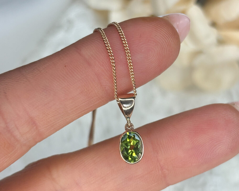 modern 9ct rose gold and oval shaped peridot pendant on an 18 inch chain for sale