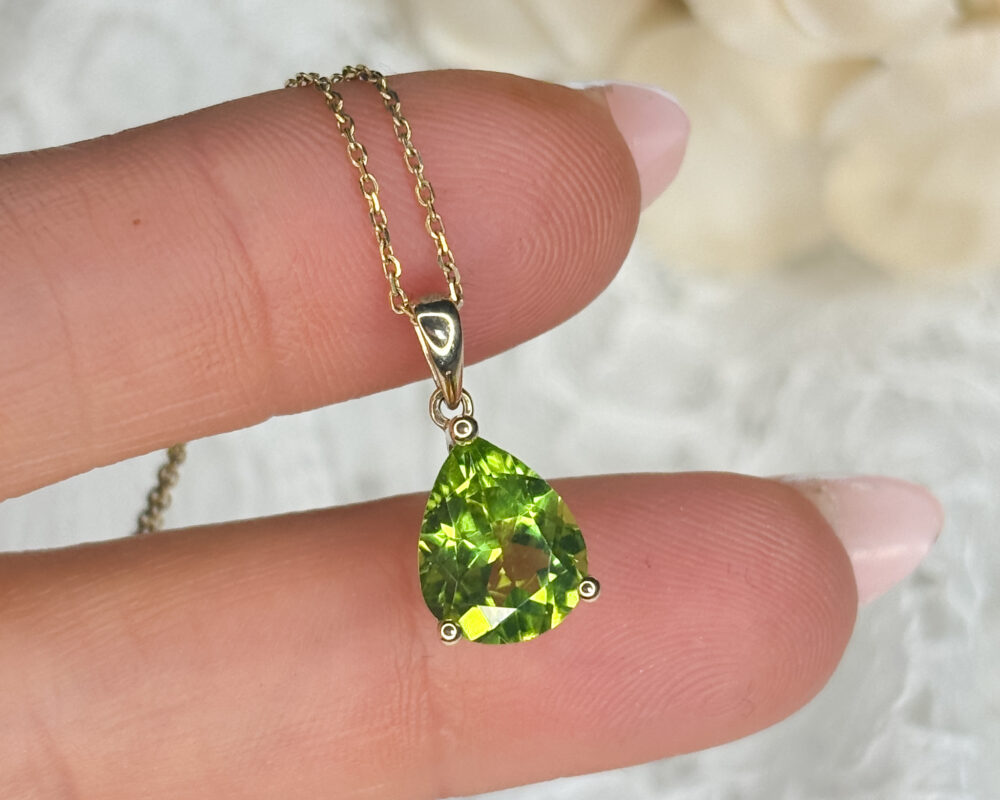 modern 9ct yellow gold and pear cut peridot pendant on an 18 inch gold chain for sale
