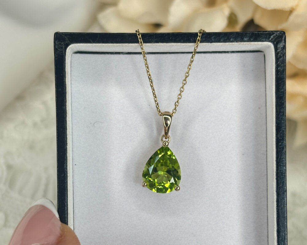 modern 9ct yellow gold and pear cut peridot pendant on an 18 inch gold chain for sale