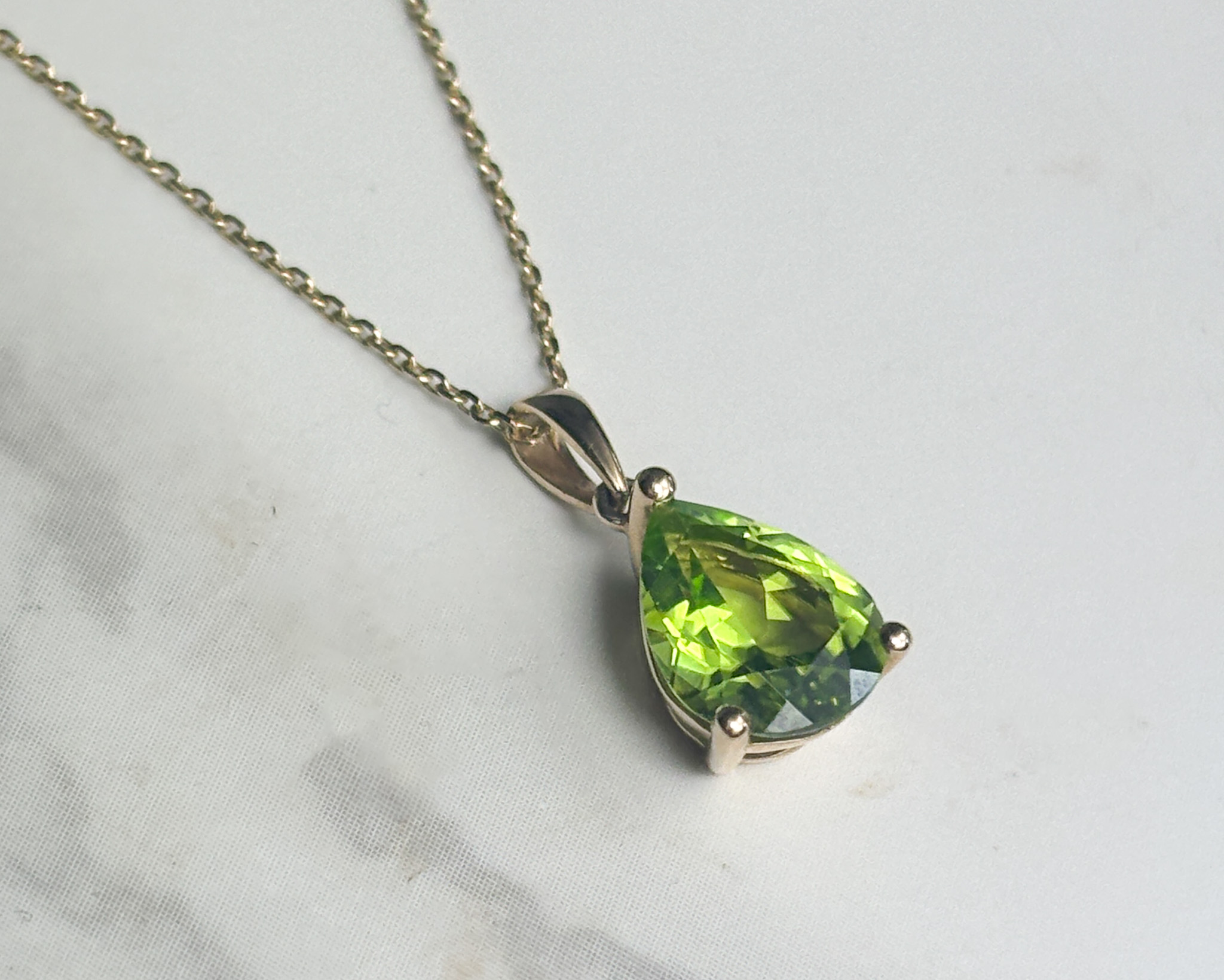 modern 9ct yellow gold and pear cut peridot pendant on an 18 inch gold chain for sale