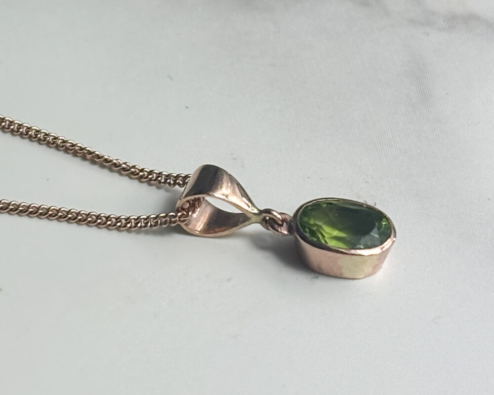 modern 9ct rose gold and oval shaped peridot pendant on an 18 inch chain for sale
