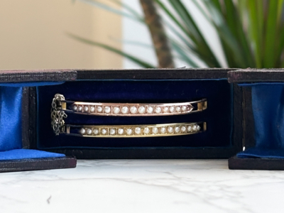 rare pair of antique Victorian rose gold and yellow gold seed pearl bangles in original box for sale in Leeds, UK