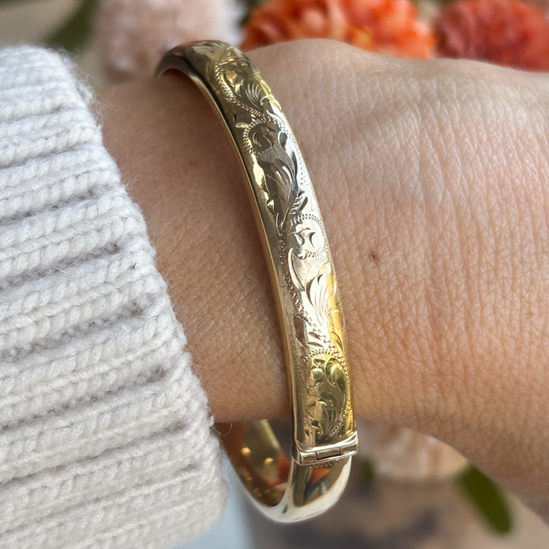vintage 9ct gold engraved bangle on woman's wrist for sale in Leeds, Yorskhire