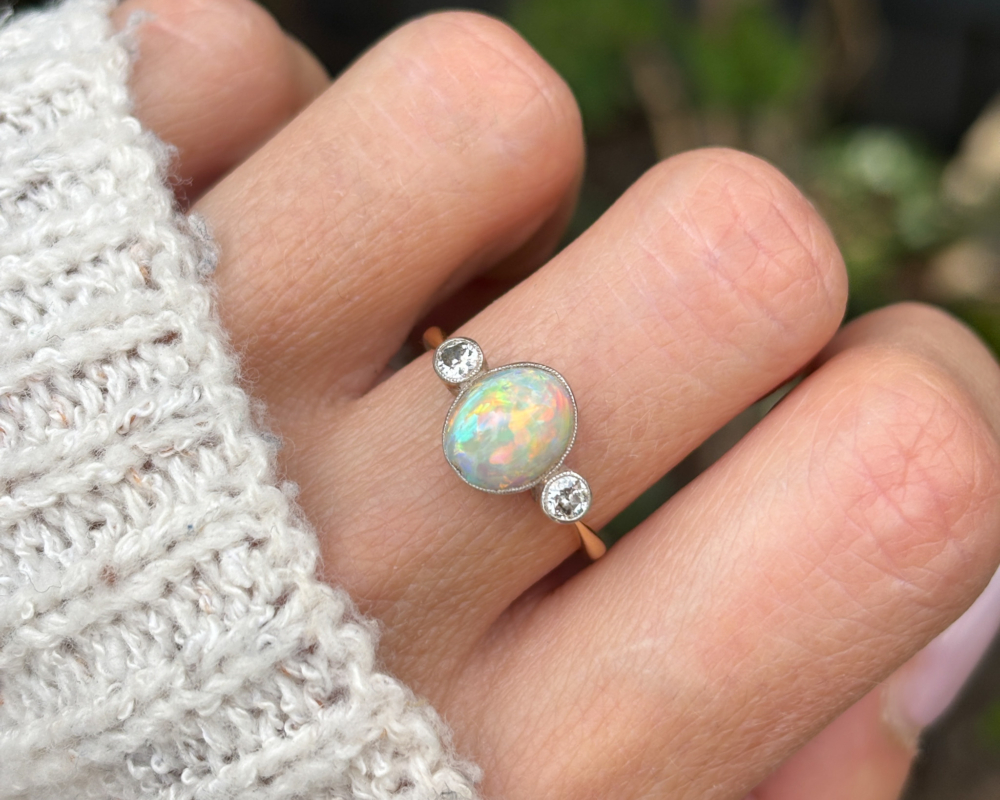 antique Victorian opal and diamond three stone ring on lady's hand
