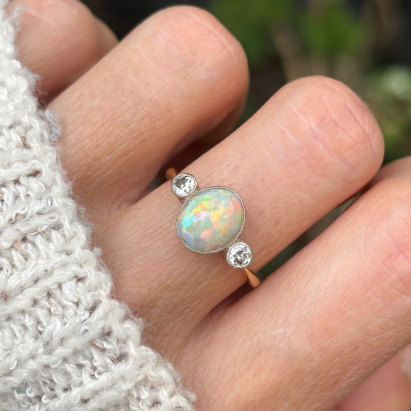 antique Victorian opal and diamond three stone ring on lady's hand