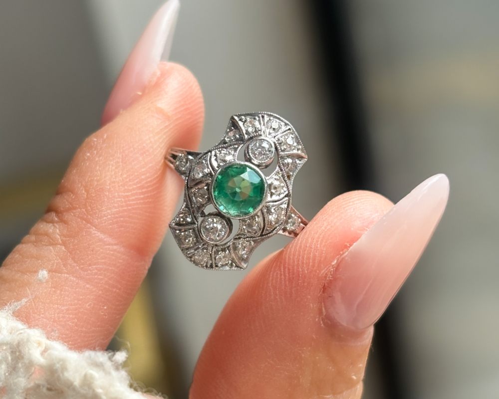 antique Art Deco paste and diamond ring set in platinum. Shown in between fingers in Leeds, Yorkshire, UK