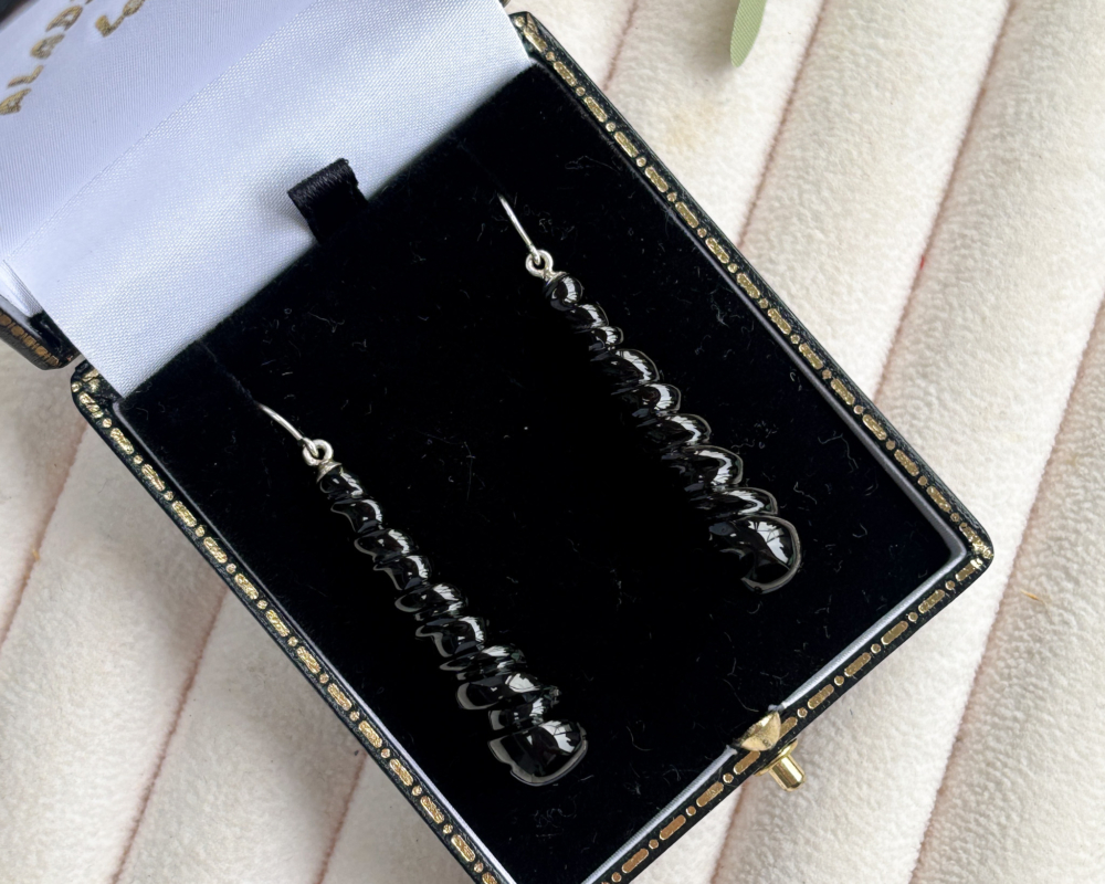silver and whitby jet long dangly hand carved earrings for pierced ears shown in a box