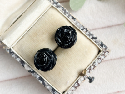 antique Whitby Jet stud earrings with silver backs shown in a presentation box