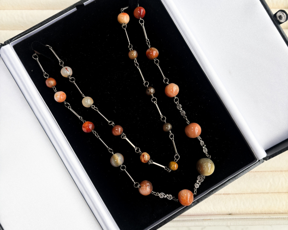 antique 1920s agate beads for sale, laying on box