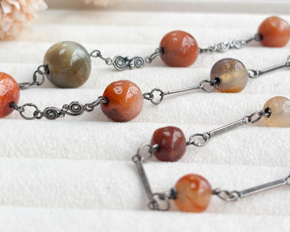 antique 1920s agate beads for sale, laying on box