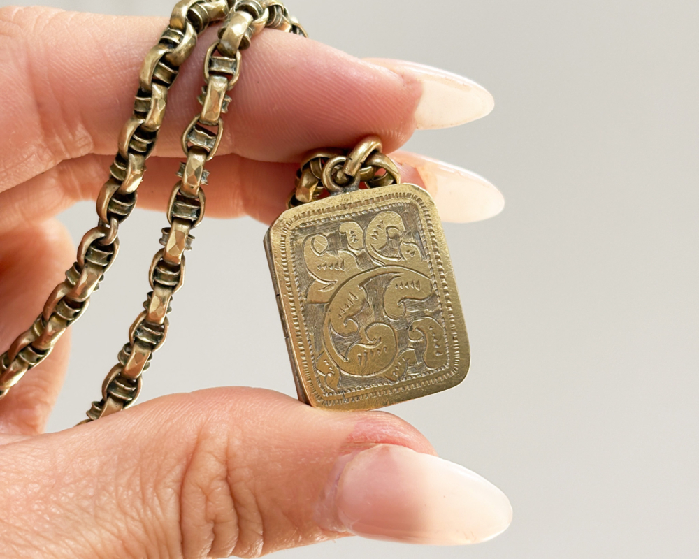 Victorian locket and chain for sale in Leeds, shown held in lady's fingers