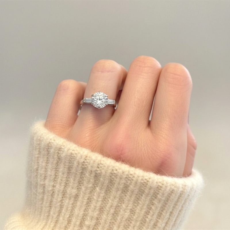 antique Art Deco 2ct diamond solitaire ring in platinum with baguette diamonds for sale in Leeds, UK, on model's hand