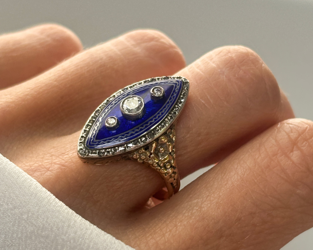 early Victorian cobalt blue enamel and old cut diamond navette ring for sale in Leeds, set in 15ct gold, shown on lady's finger