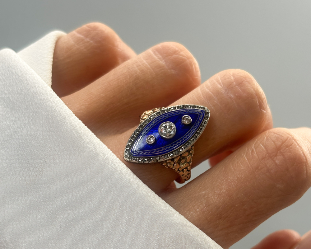early Victorian cobalt blue enamel and old cut diamond navette ring for sale in Leeds, set in 15ct gold, shown on a lady's finger