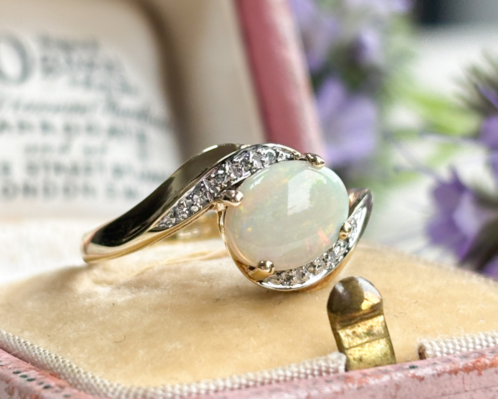 vintage 9ct gold, opal and diamond twist ring for sale in Leeds, UK, shown on a pink box