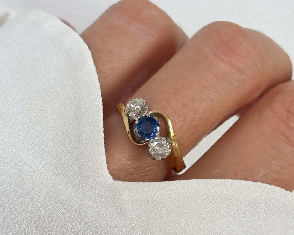 antique 1930s sapphire and diamond three stone twist ring in 18ct yellow gold for sale in Leeds, Yorkshire, shown worn on a lady's finger