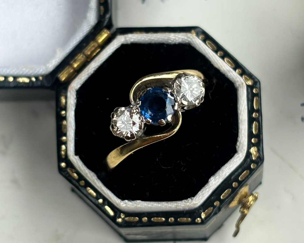 antique 1930s sapphire and diamond three stone twist ring in 18ct yellow gold for sale in Leeds, Yorkshire, shown in a ring box