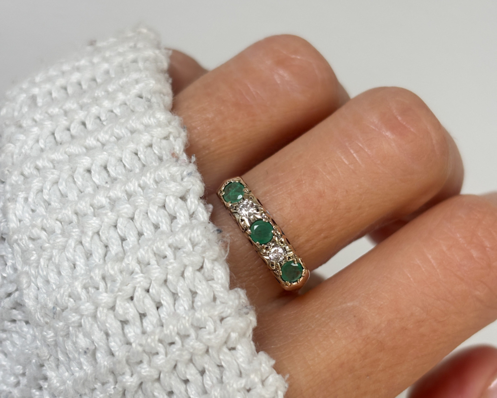 vintage mid century emerald and diamond ring in 9ct gold for sale in Leeds, UK, shown on lady's hand